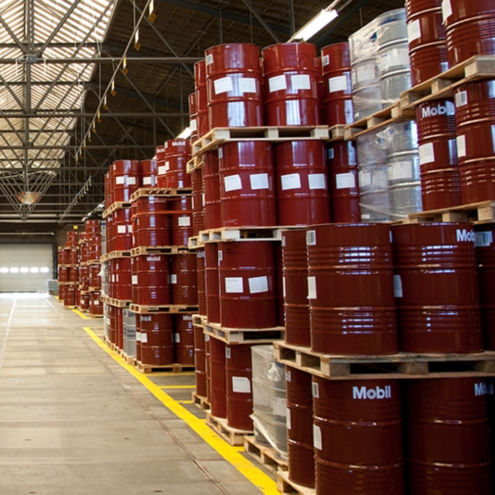 industrial lubricant drums stored in warehouse representing trusted brands and reliable industrial supply