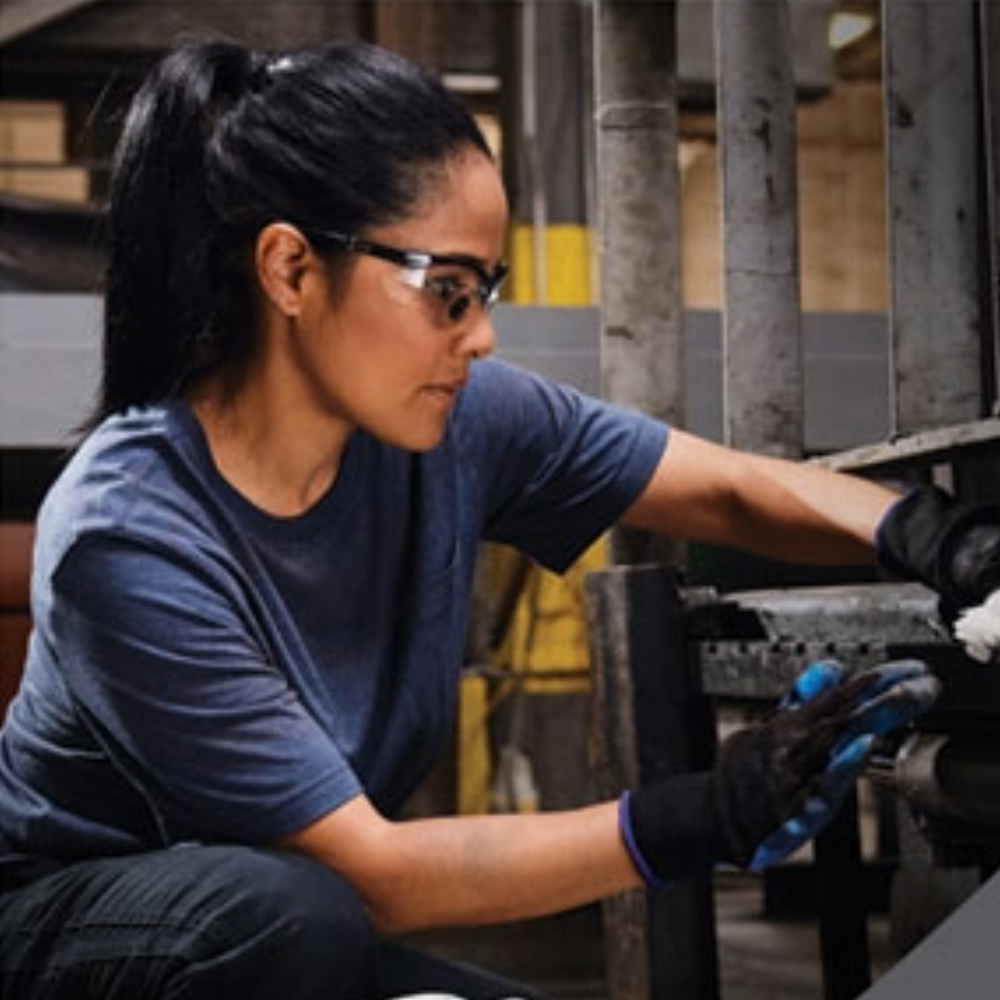 Industrial wiping cloth cleaning machinery using WypAll Kimberly-Clark professional wipes in workshop